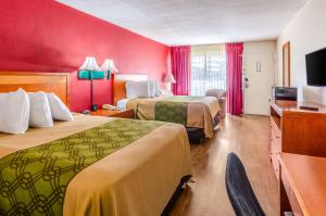 a hotel room with two beds and a flat screen tv at Econo Lodge in Martinsville