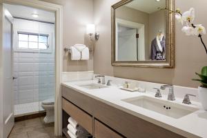 a bathroom with a sink and a mirror and a toilet at L'Auberge De Sedona in Sedona