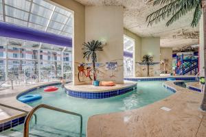 a large indoor swimming pool in a building at Dunes Village in Myrtle Beach