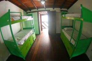 Cama ou camas em um quarto em Pousada Tubes Maresias