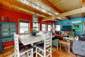 a dining room with a wooden table and red walls at Casa de Nieve - Snow House"" in Steamboat Springs