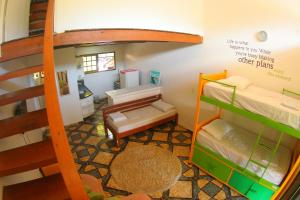 Cama ou camas em um quarto em Pousada Tubes Maresias