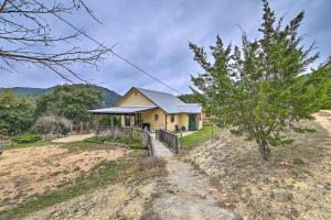 a house on top of a hill with a tree at Cozy Medina Cottages with Patio and Mountain Views! in Medina