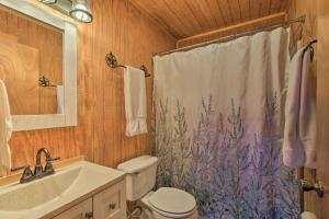 a bathroom with a toilet and a shower curtain at Cozy Medina Cottages with Patio and Mountain Views! in Medina +28 photos
