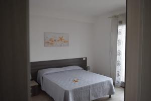a bedroom with a bed with a table in it at Appartamenti AcquaChiara in San Vito lo Capo