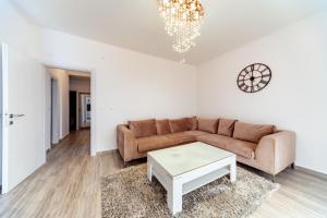 a living room with a couch and a table at Apartments Monte Re in Petrovac na Moru