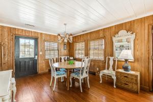 a dining room with a table and chairs at Clervue Cottage in Folly Beach