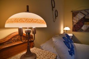 a lamp sitting on a table next to a bed at Studio Maistros in Galaxidi