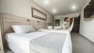 Un ou plusieurs lits dans un hébergement de l'établissement Danieri Asunción Hotel