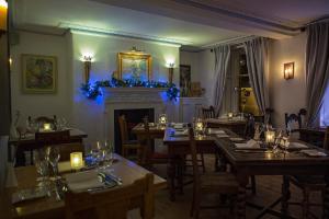 a dining room with wooden tables and a fireplace at The Frenchgate Restaurant & Hotel in Richmond