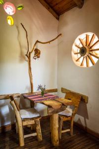 a dining room with a wooden table and chairs at Cabañas Las Moras in Tandil