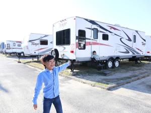 a young boy standing in the street next to an rv at Grampus Inn Shirahama in Shirahama