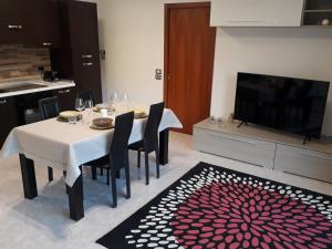 a dining room with a table with chairs and a tv at Elite Apartments in Perugia