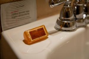 a bottle of soap sitting on a bathroom sink at The Historic Taos Inn in Taos