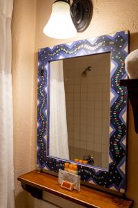 a mirror on top of a shelf in a bathroom at The Historic Taos Inn in Taos