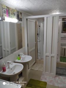 a bathroom with two sinks and a shower at Like Home Hostel in Tiraspol