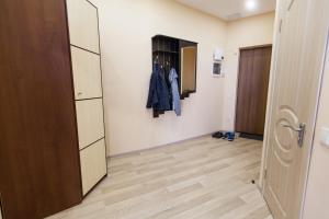 a room with a hallway with a closet and a door at Sun City Apart Hotel in Dnipro