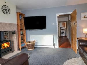 a living room with a fireplace and a flat screen tv at Fieldside in Belper