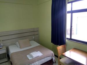Postel nebo postele na pokoji v ubytování Esplendor Palace Hotel