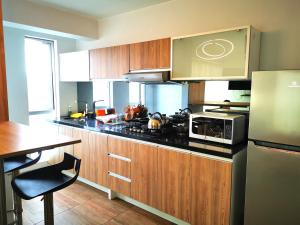 a kitchen with wooden cabinets and a stove top oven at Residencial Cafferata in Lima