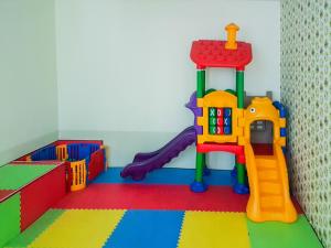 a childs play room with a toy playground at Modern Design 1BR Apartment at Brooklyn Alam Sutera By Travelio in Tangerang
