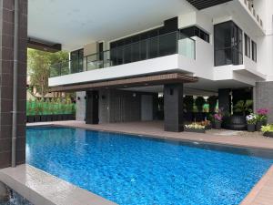 a house with a swimming pool in front of it at Top Floor Gorgeous Sunset View - Mae Phim Beachfront Condo in Mae Pim