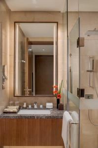 a bathroom with a sink and a large mirror at Dusit Thani Residence Davao in Davao City