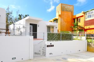 a view of the front of a house with white fences at Annex B Onna in Onna