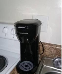 a black blender sitting on a counter next to a sink at Cozy 1 BR Efficiency Apt close to TTU and Downtown in Cookeville