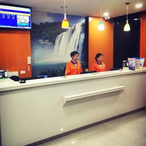 two women standing at a counter in a store at 7Days Inn Guiyang Jinyang Century City Shopping Center in Guiyang