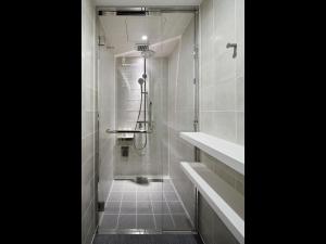 a bathroom with a shower with a walk in shower at 9h nine hours Hamamatsucho in Tokyo