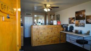 a kitchen with a wooden door in a room at Fort Verde Suites in Camp Verde