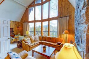 a living room with a couch and a large window at Wildflowers Chalet in Silverthorne