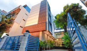 a building with a blue staircase in front of it at The Mount City Near US Consulate in Chennai