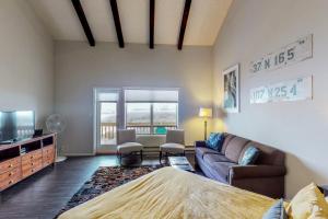 a bedroom with a bed and a couch and a tv at Aspenwood 4220 in Pagosa Springs