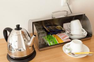 a toaster sitting on a table with a tea kettle at Machiya no Yado Iroha in Nagahama