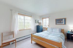 a bedroom with a bed and a chair and a window at Steamboat Springs 1308 in Steamboat Springs