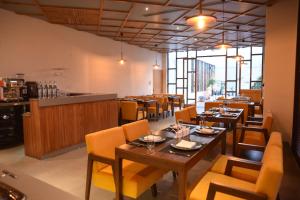 a restaurant with tables and chairs and a bar at HOTEL ICON Rajpura in Rājpura