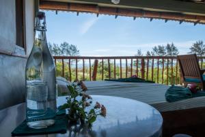 a bottle of wine sitting on top of a table at Kudakalliya Beach House in Arugam Bay