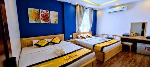 Postel nebo postele na pokoji v ubytování Hoàng Gia Hotel Côn Đảo