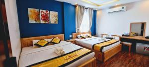 Postel nebo postele na pokoji v ubytování Hoàng Gia Hotel Côn Đảo