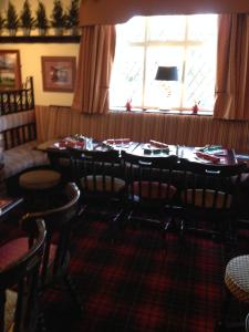 a dining room with a table and chairs and a window at New Masons Arms in Leeds