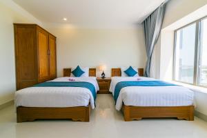 Postel nebo postele na pokoji v ubytování Navy Hotel Cam Ranh