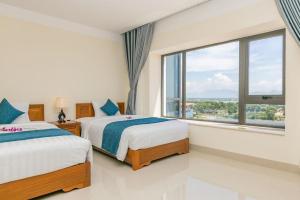 Postel nebo postele na pokoji v ubytování Navy Hotel Cam Ranh