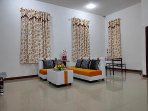 a living room with two couches and a table at Red Perdana in Pontianak