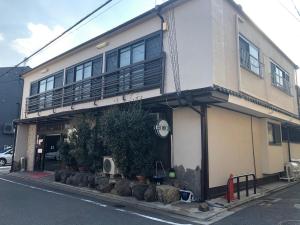 a building with a balcony on the side of it at Takigawa Ryokan in Kyoto