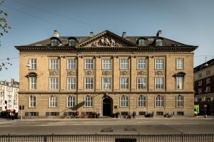 a large brick building on a city street at Nobis Hotel Copenhagen, a Member of Design Hotels in Copenhagen