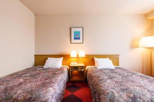 Postel nebo postele na pokoji v ubytování Fukuno Town Hotel A・Mieux + 37 fotografií
