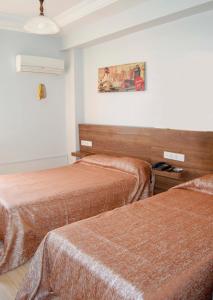 Ein Bett oder Betten in einem Zimmer der Unterkunft Yunus Hotel