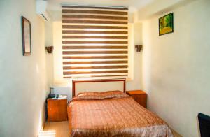 Ein Bett oder Betten in einem Zimmer der Unterkunft Yunus Hotel